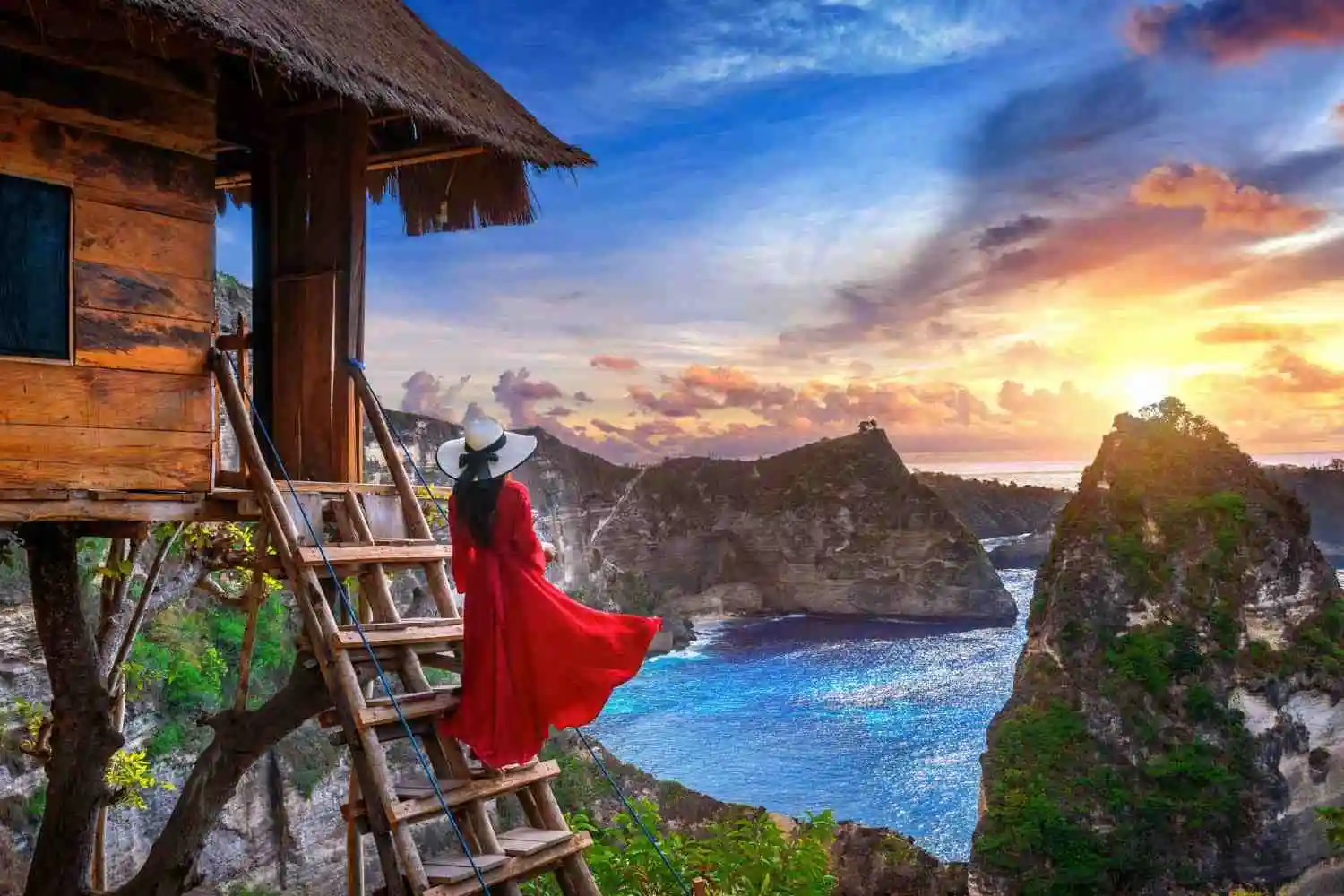 Woman enjoying sunrise view, illustrating the best places to stay in Bali
